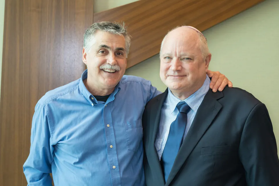 Two family members hugging at a bat mitzvah service